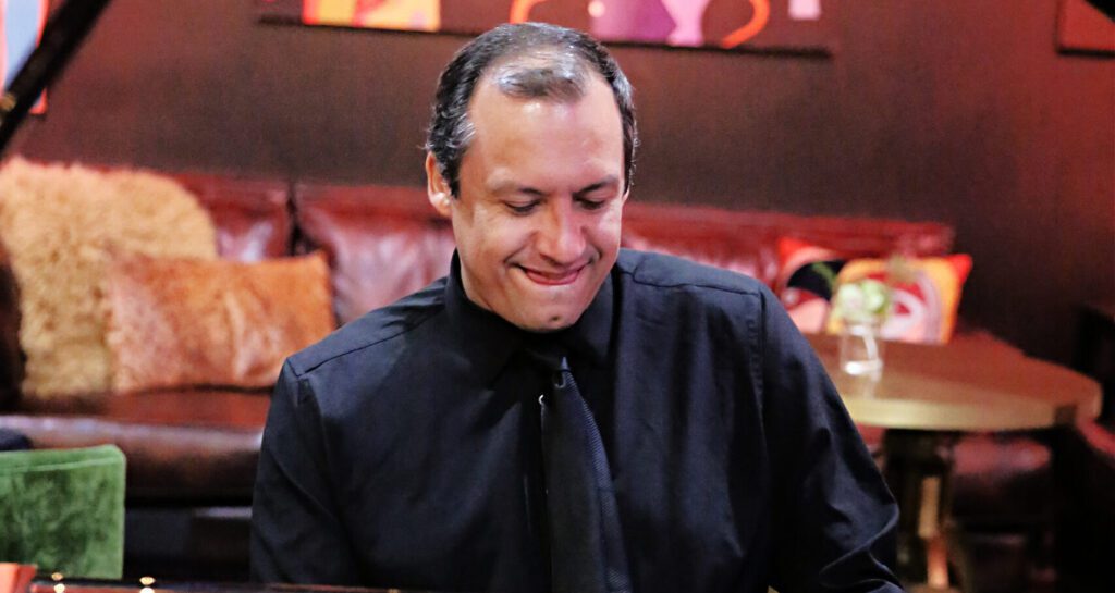 Edepson González playing piano during an intimate performance